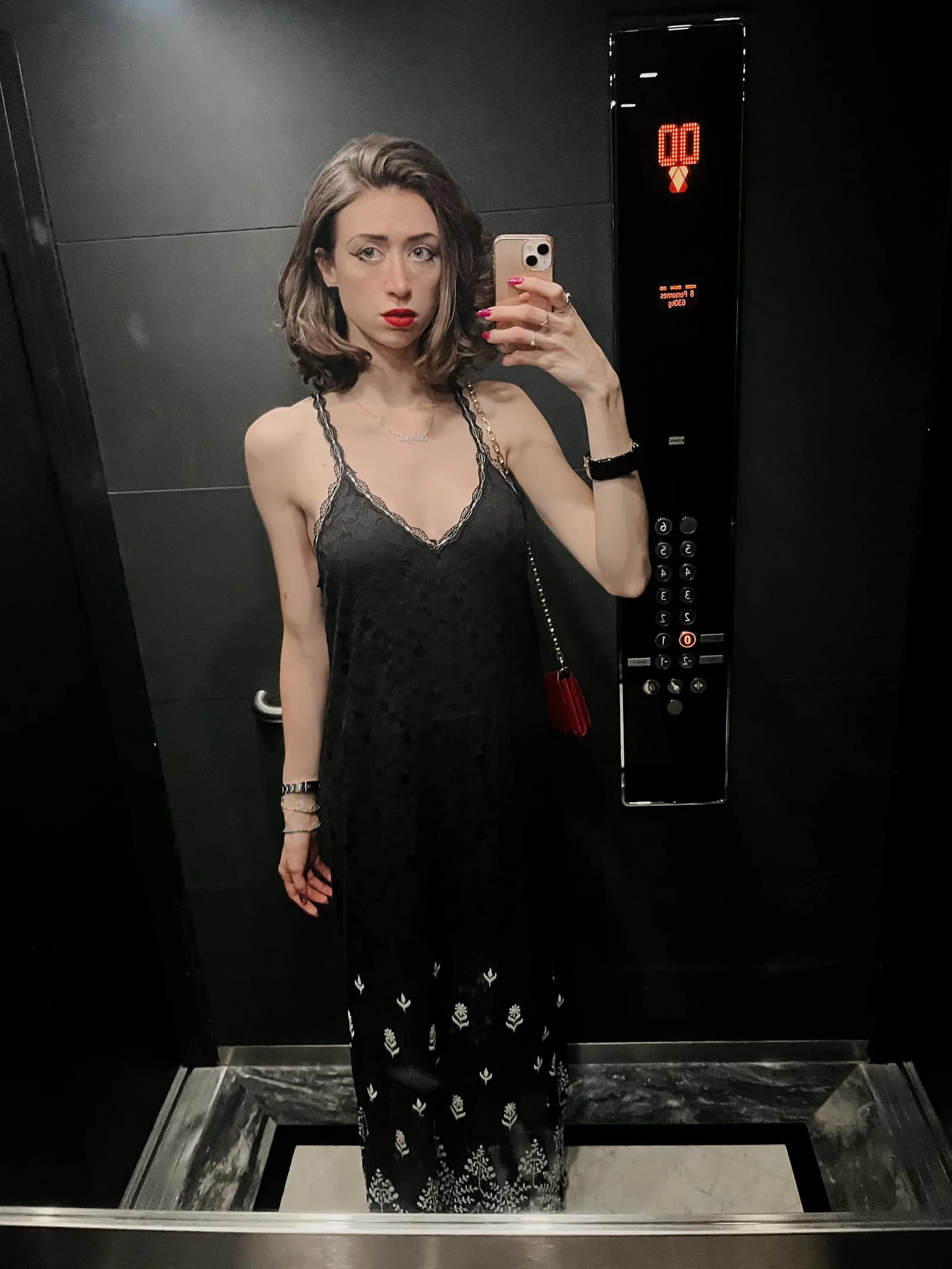Sierra “Sisi” Moses in a black slip dress