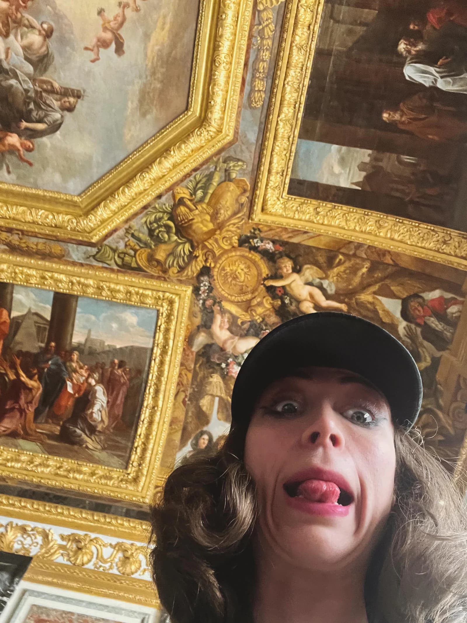 Sierra “Sisi” Moses pulling a comic face beneath an ornate painted ceiling